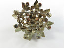 Front of signed Weiss green rhinestone and white enamel floral brooch