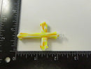Front view of yellow, orange, and opaque white art glass cross pendant