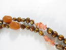 Close view of pearls carnelian beads and coral chips