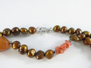 Close view of bronze-gold pearl and sterling clasp