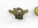 Back of USNR brass lapel pin with threaded post and round screw-back nut