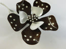 Backs of matching brown flower clip-on earrings