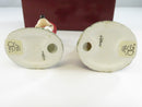 Underside view of both porcelain figurine bases showing Disney and Department 56 Made in Taiwan markings.