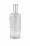 Clear glass bottle with embossed text on a white background
