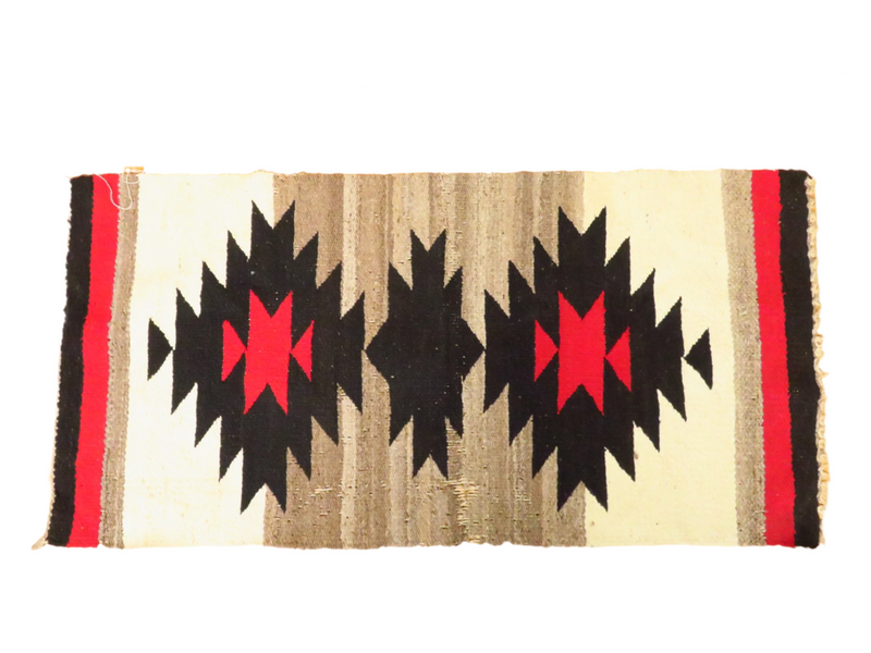 This authentic Navajo area rug is a testament to the enduring craftsmanship of the Southwest. The intricate geometric design, woven with care using natural dyes, tells a story of generations of Navajo weavers. Although showing signs of wear, the rug's patina adds to its character and charm.