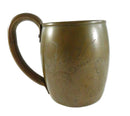 Bronze cup with engraved designs on a white background