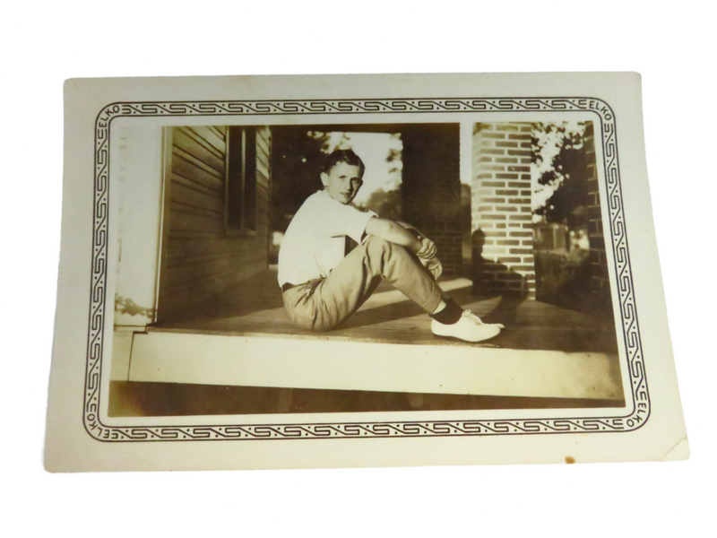 c1936 Elko Border Photograph of Young Man Sitting on Porch 5" x 3 1/4 — front view
