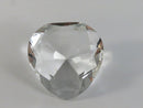 Clear faceted heart-shaped object on a gray background