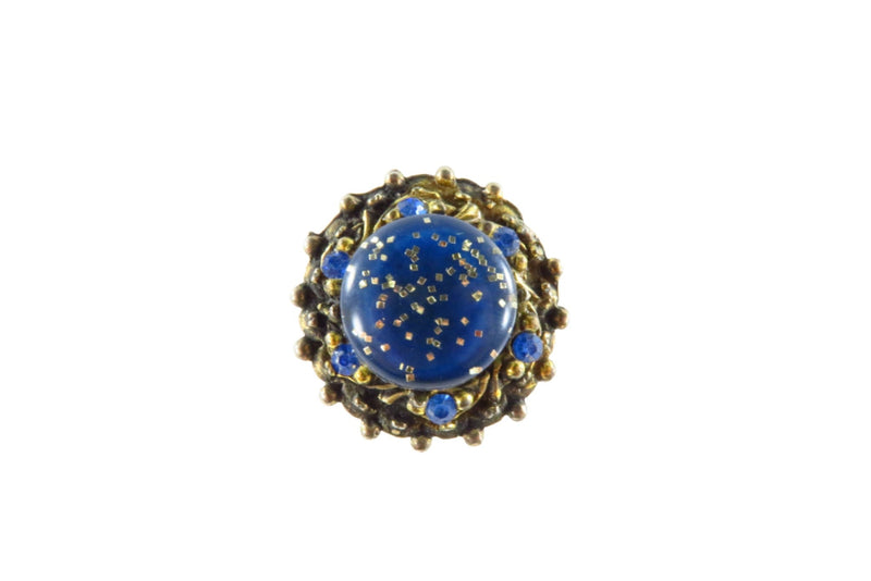 Big Bold Mogul Gilded Metal Blue Stone Surround Blue Resin Adjustable Ring — front view