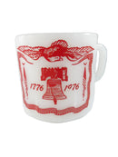 White mug with red eagle and liberty bell design on a white background