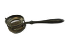 Vintage metal coffee and tea strainer with black handle on a white background