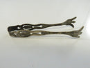 Side view of Weidlich sterling silver sugar tongs
