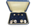 Close-up of cufflinks and shirt studs with mother of pearl inlays