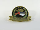 Commemorative lapel pin featuring NC flag and laurel wreath