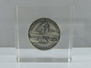 Close-up of Stanley Home Products coin paperweight