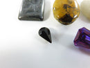 Loose Gemstone and Bead Lot with Hematite Intaglio and Synthetic Stones Purple Stone Plastic Oval Unidentified White Sto