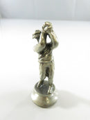 Pewter golf-themed chess piece in mid-swing
