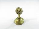 Brass colored chess piece on flared base
