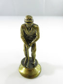Brass colored chess piece on flared base