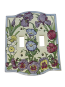 Front view of Santa Barbara Ceramic Design 1994 ceramic 2-gang toggle switch plate with floral botanical border and T.L.B. marking