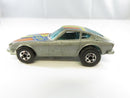 Left-side view of Hot Wheels Z Whiz silver Datsun coupe with DATSUN hood graphics, blue-tinted windows, and blackwall wheels.