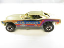 Side view of Hot Wheels Hemi Hauler gold funny car showing HEMI HAULER, Goodyear, and AC side graphics