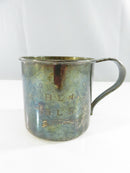 Rear view of the child's cup showing the floral relief design on the handle and gold-washed interior