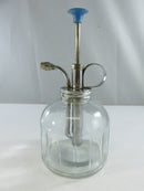 Top view of the metal pump assembly and finger ring handle on the clear glass plant mister