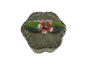 Top view of vintage pierced wire mesh trinket box with red, white, and green enamel flower and leaf lid finial