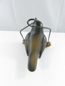 Close front view of the robin figurine's reddish-orange breast, feet, and textured faux bark perch