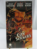 Back of factory-sealed City Slickers VHS slipcover showing synopsis, barcode, cast credits, PG-13 rating, and 114-minute runtime