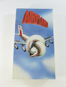 Front of Airplane! VHS slipcover with red title lettering and airplane artwork