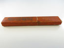 Close view of one end and the textured reddish-brown paper covering on the Worcester Razor Co slide box