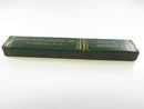 Angled front view of the closed dark green two-piece Carl Monkhouse Jr. razor slide box