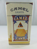 Back of sealed Camel Lights pack showing C-Note Camel Cash promotion with All-Seeing Eye and pyramid graphic