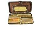 Open Valet Auto Strop razor set in brown metal tin with gold-tone razor, handle, blade holder, strop, and instructions