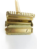 Closed brown metal Valet razor tin showing paint loss and crazing on the lid