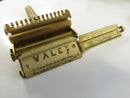 Angled rear view of closed brown metal razor tin with worn finish