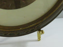 Back view of the oval frame with intact brown paper backing and attached hanging wire.