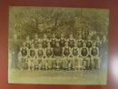Close view of the Saint Benedict's team photograph showing athletes in B uniforms and trophy display.