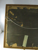 Close-up of damaged backing paper and crossed hanging wire on the rear of the frame.