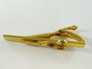 Back view of gold-tone barber shears tie bar with spring-tension alligator clip