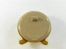 Rear view of the round celluloid case showing faux-ivory grain and missing easel support.