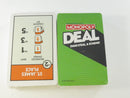 Two sealed Monopoly Deal card decks showing a Monopoly Deal card back and St. James Place property card.