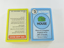 Two sealed Monopoly Deal card decks showing a Tips and Rules card and House action card.