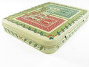 Open hinged collector tin holding green and red Bicycle Rider Back card decks