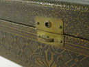 Underside view of the glove box showing torn and missing sections of the paper bottom backing.
