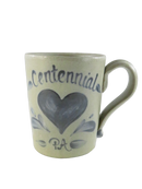 Front view of Rowe Pottery Works Centennial PA stoneware mug with cobalt blue heart, floral accents, and handle.