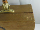 Open wooden box purse showing the brown vinyl lining, interior pocket, brass hardware, and leather side hinges.