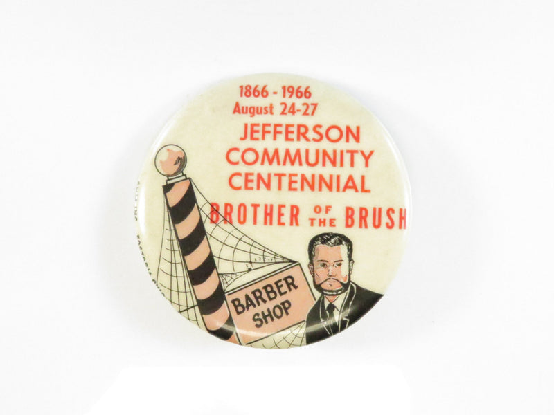 Button badge celebrating Jefferson Community Centennial with a barber shop theme.